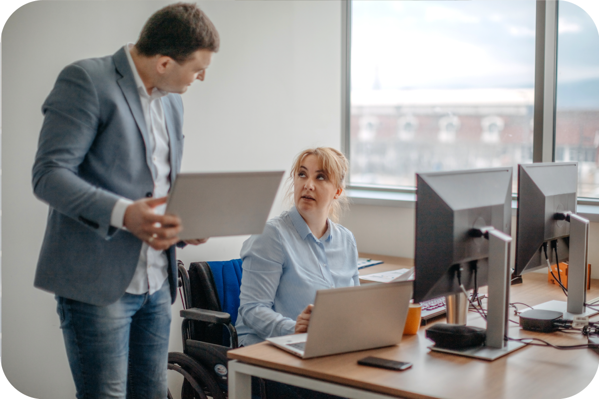 Two business professionals having a discussion within the woman's office