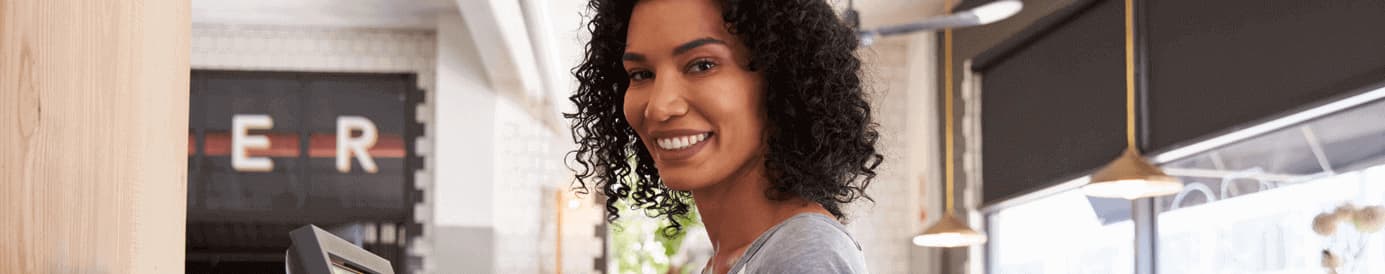 A woman looks forward and smiles