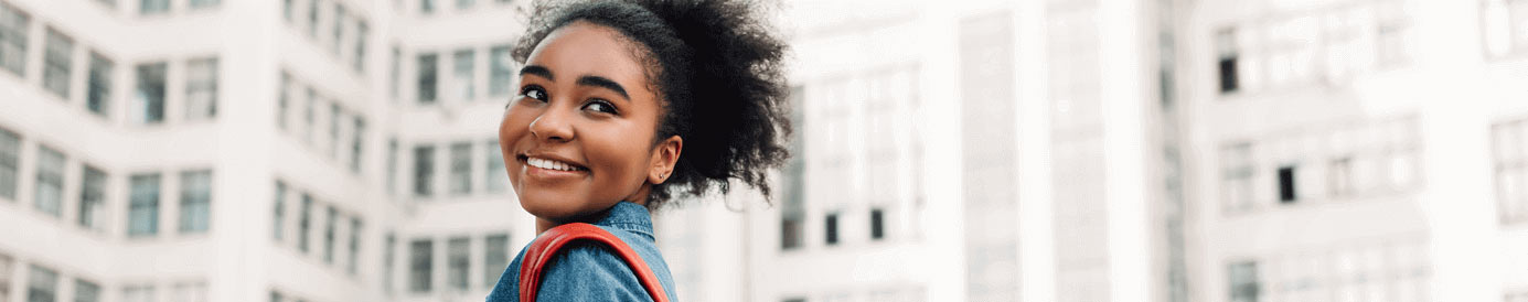A woman looking back over her shoulder and smiling