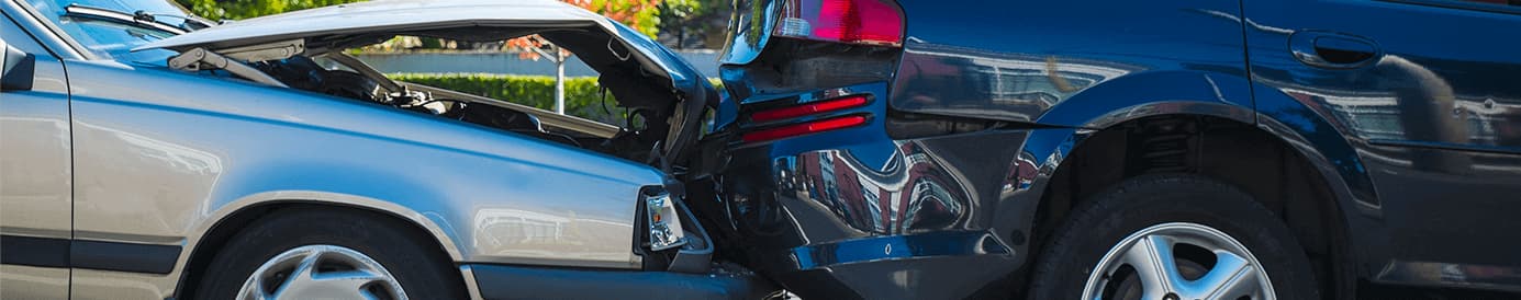 A black car being rear ended by a silver car