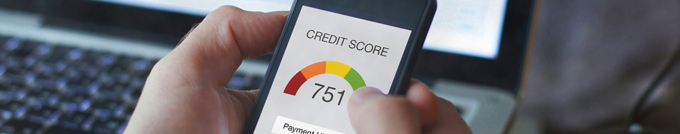 Hands hold a mobile phone with a credit app open. The header reads “Credit Score” followed by a score gauge that reads “751”.