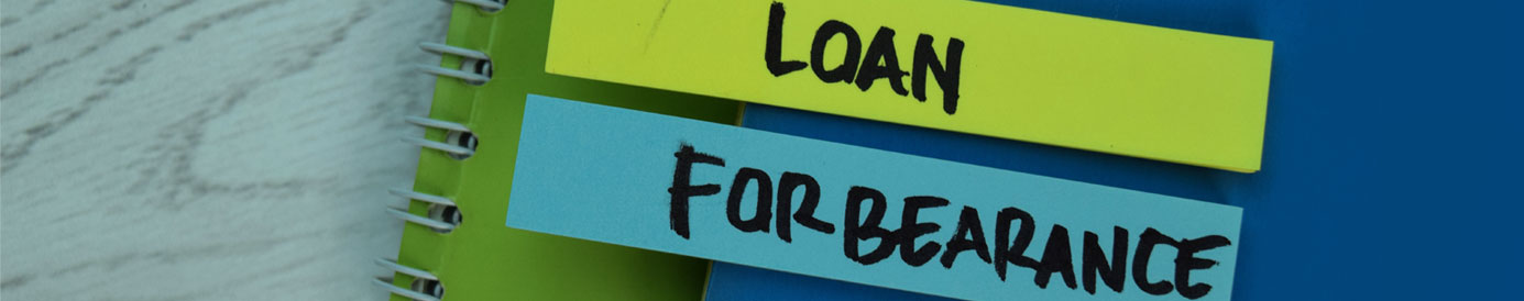 The word 'loan' is written on a yellow sticky tab, and the word 'forbearance' is written on a blue sticky tab. Both are attached to a stack of notebooks.