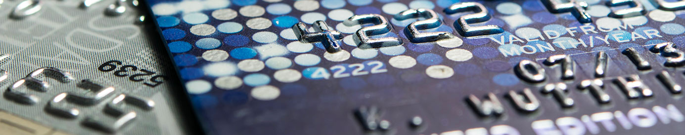 Several credit cards are laid out on a tabletop.