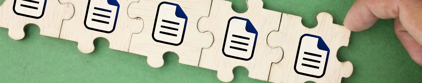 A hand links puzzle pieces together in a row on a green surface. Each puzzle piece has the image of a file icon printed on it.