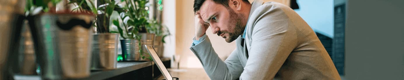 A man focusing on a laptop screen