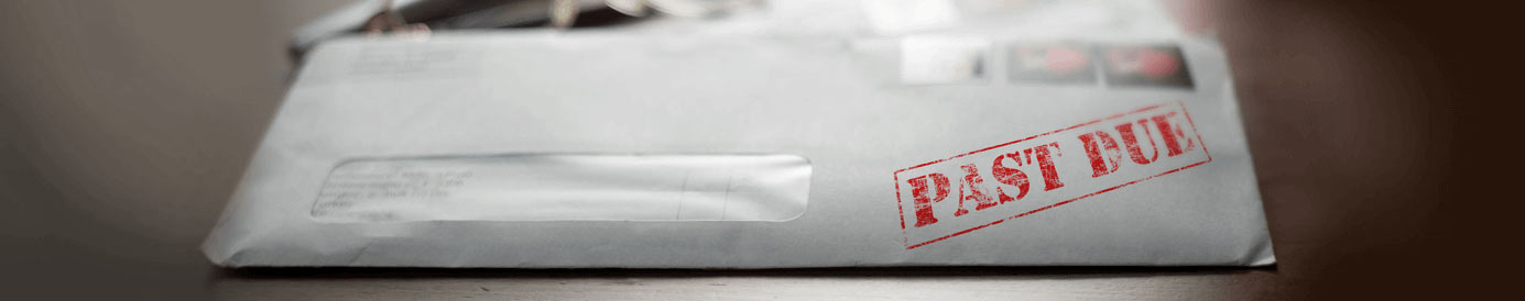 A white maining envelope with the words PAST DUE stamped on the front of it