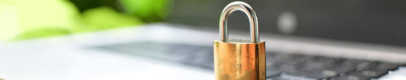 A padlock resting on an opened laptop