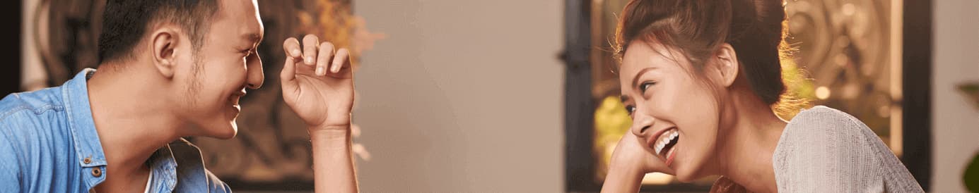 A man and a woman looking at each other and smiling