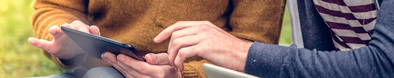 Two people working together on a tablet