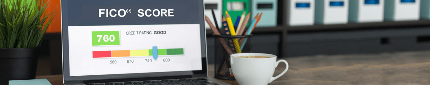 A laptop screen showing a FICO score of 760 which a sliding scale shows as GOOD with a white coffee mug and a cannister of pencils sitting next to the laptop