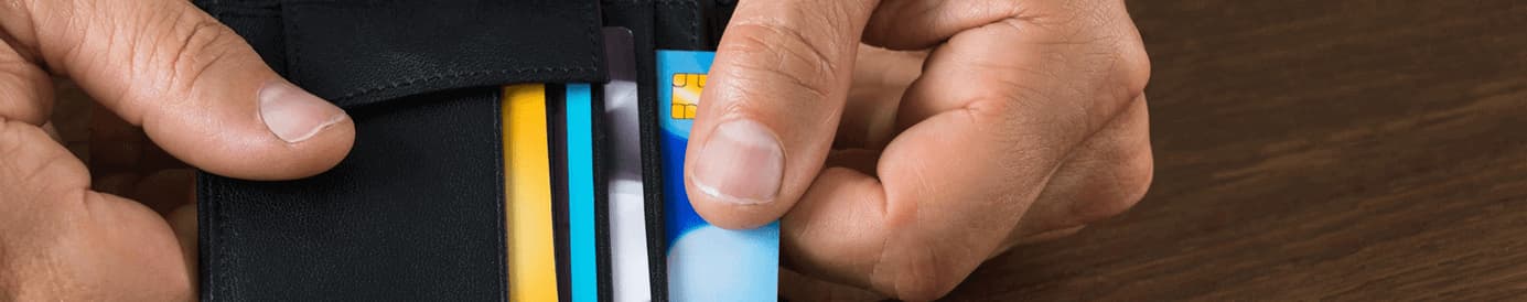 Hand removing credit card from wallet