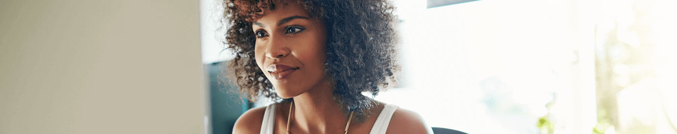 A woman smiles and stares forward