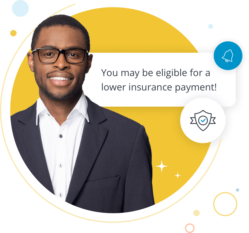 Young African American man wearing a suit and glasses. Copy reads: You may be eligible for a lower insurance payment!