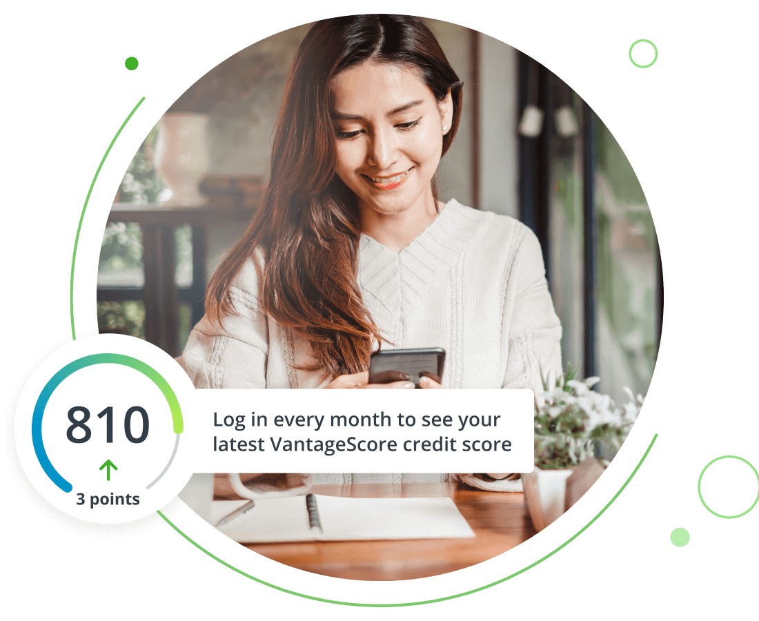 Young woman smiling while looking at her cell phone