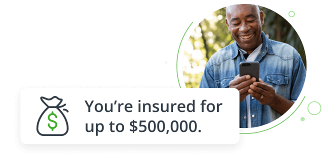 Man outdoors smiling while reading his cell phone