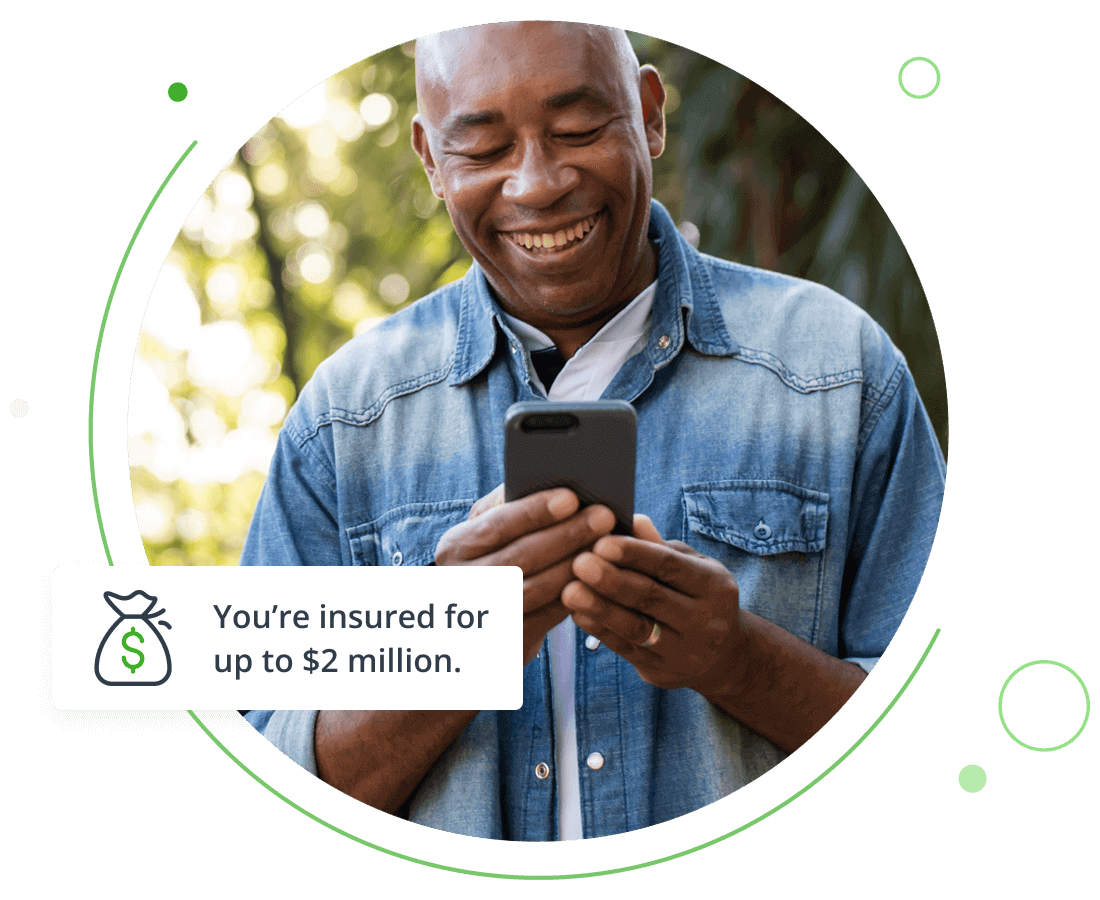 man looking at something on his cell phone and smiling