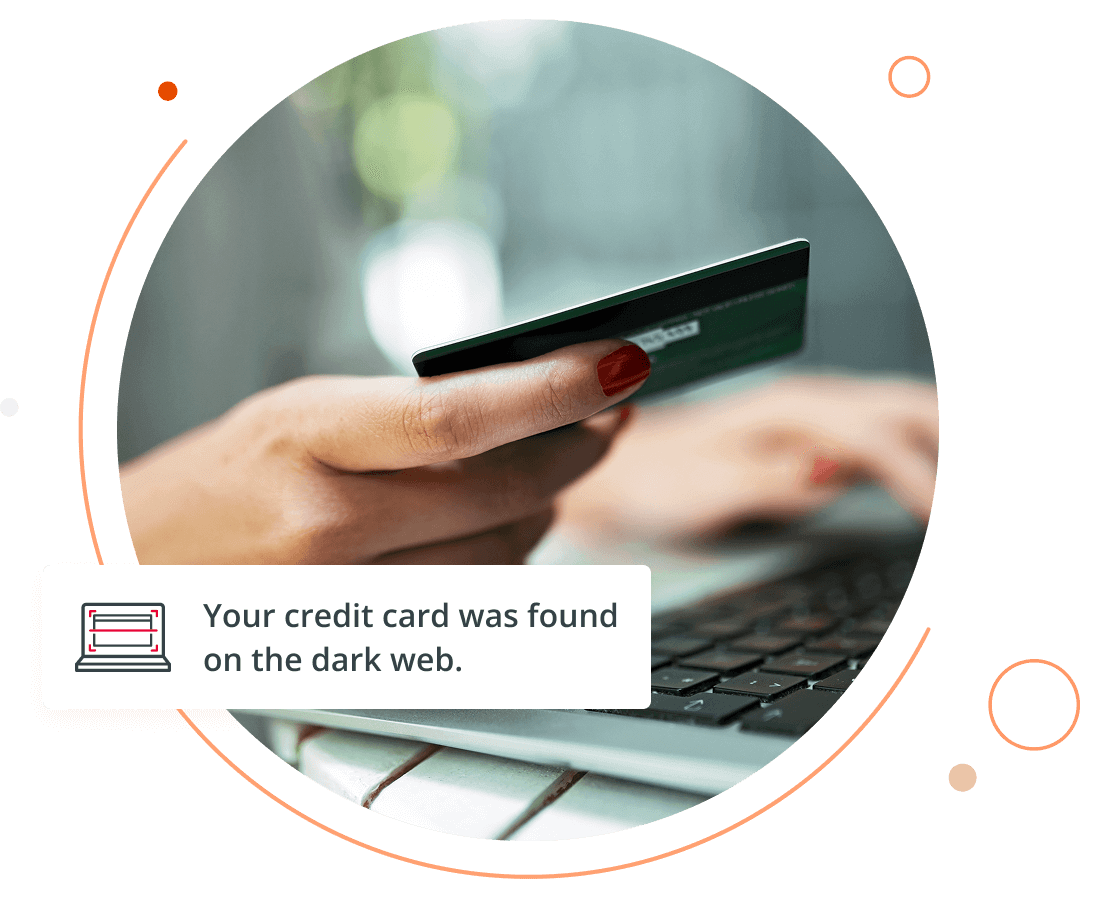 woman holding a credit card at her computer