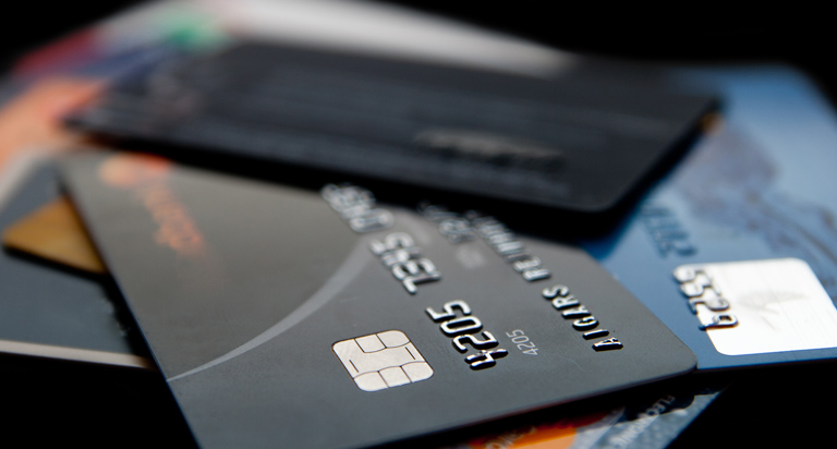 Credit cards spread across a laptop keyboard