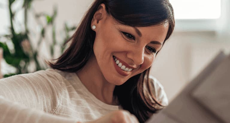 A woman looking down and smiling