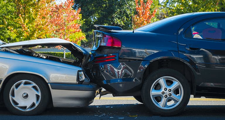 A black car rear ended by a silver car