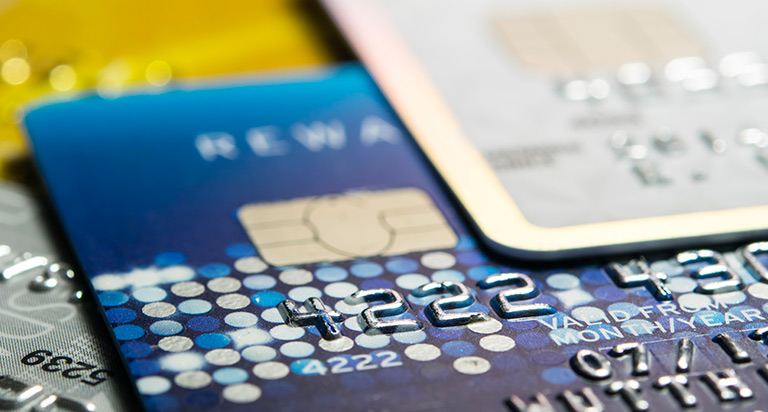 Several credit cards are laid out on a tabletop.