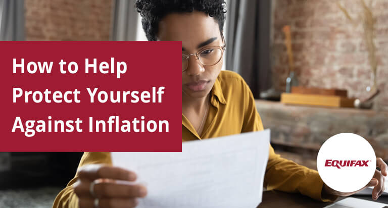 A woman at a desk with a laptop holds a document in her hand. “How to Help Protect Yourself Against Inflation” is overlaid.