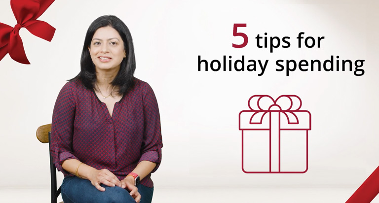 A smiling woman with black hair sits in a chair with her arms in her lap. The text “5 Tips for holiday spending” is overlaid.