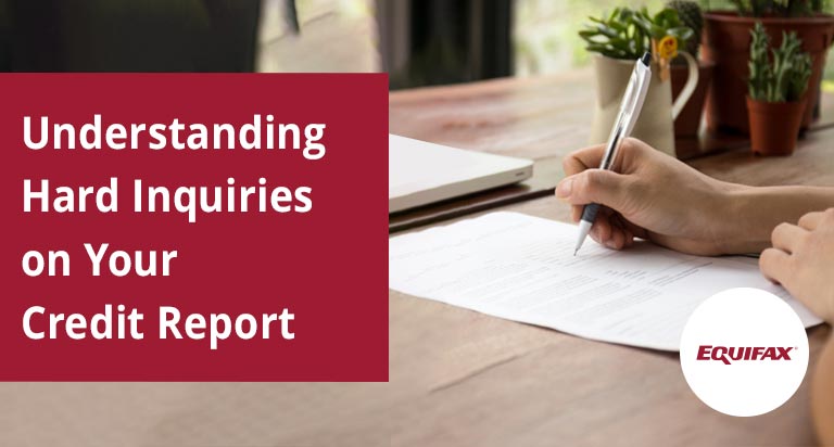 A tabletop with a document being signed in front of a laptop. The text 'Understanding Hard Inquiries on Your Credit Report' is overlaid.