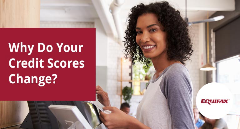 A dark haired woman smiles as she taps a touch-screen. The text 'Why Do Your Credit Scores Change?' is overlaid.