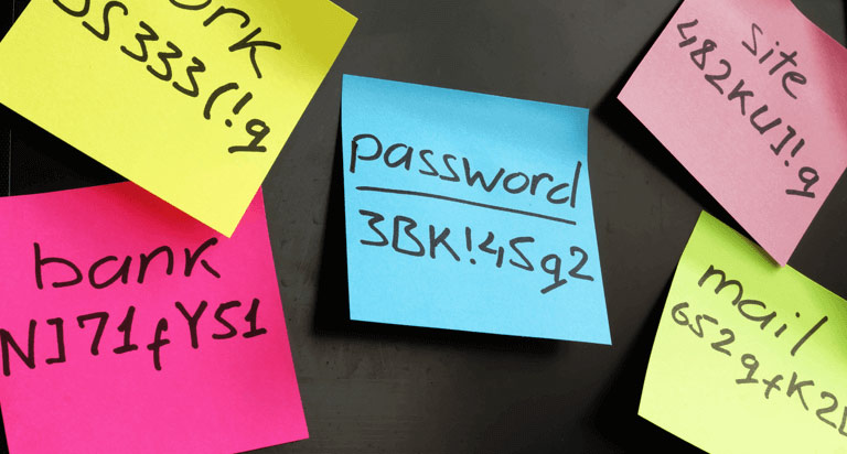 Five sticky notes of varying colors each with a different password written on them