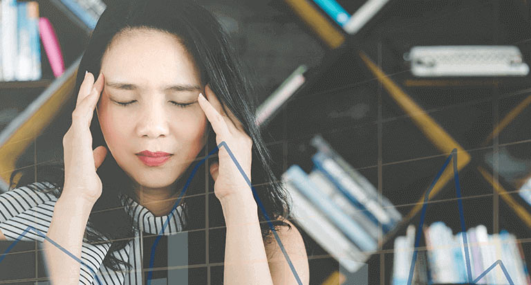 A woman holding her head with both hands