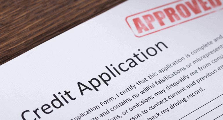 A credit application form with the word APPROVED stamped in the upper right hand corner
