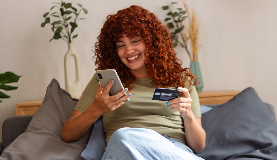 Girl making a purchase on the phone writing the credit card info