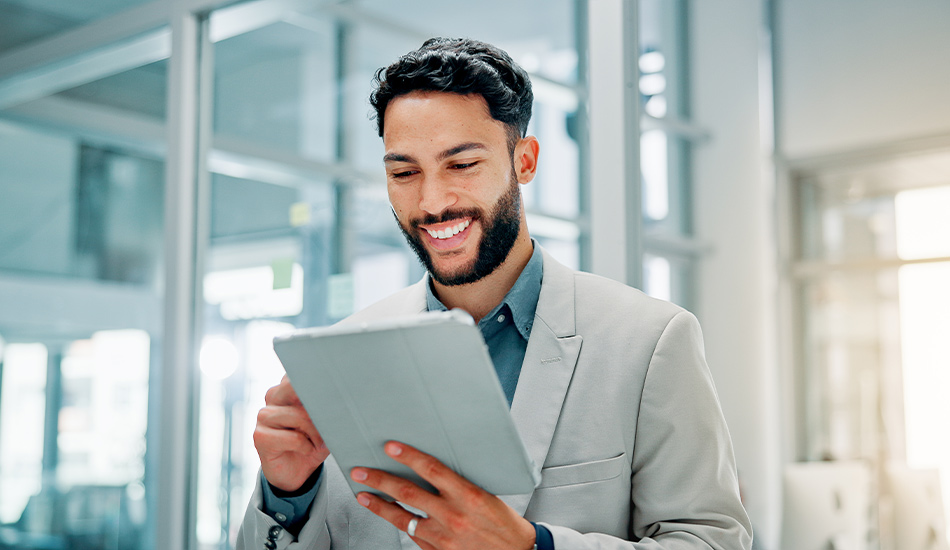Young man reads good news on a handheld tablet