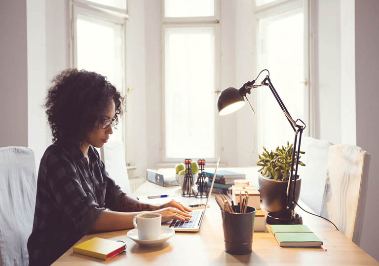 Woman working on laptop at desk