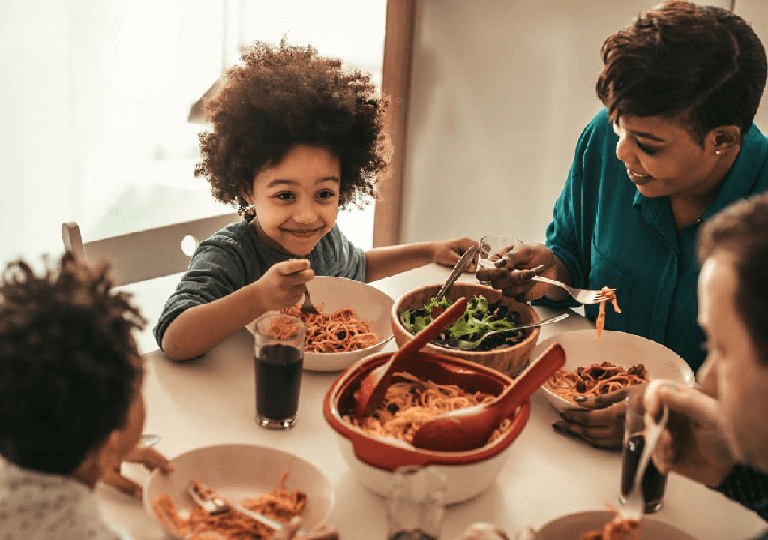 Diverse family eating dinner