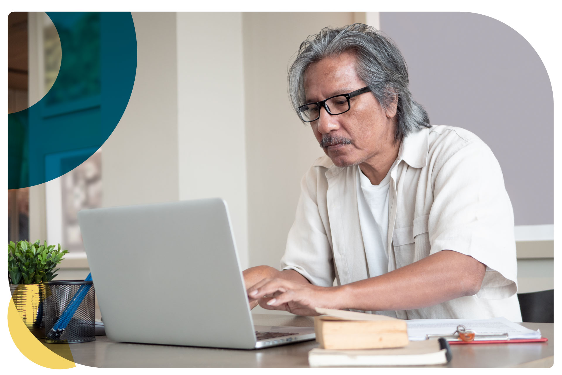 Middle aged Asian man working at his computer